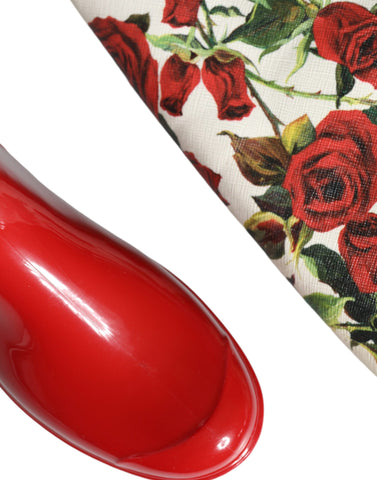 Red floral rubber knee-high flat boots by Dolce & Gabbana with a vibrant floral pattern and sleek flat sole.