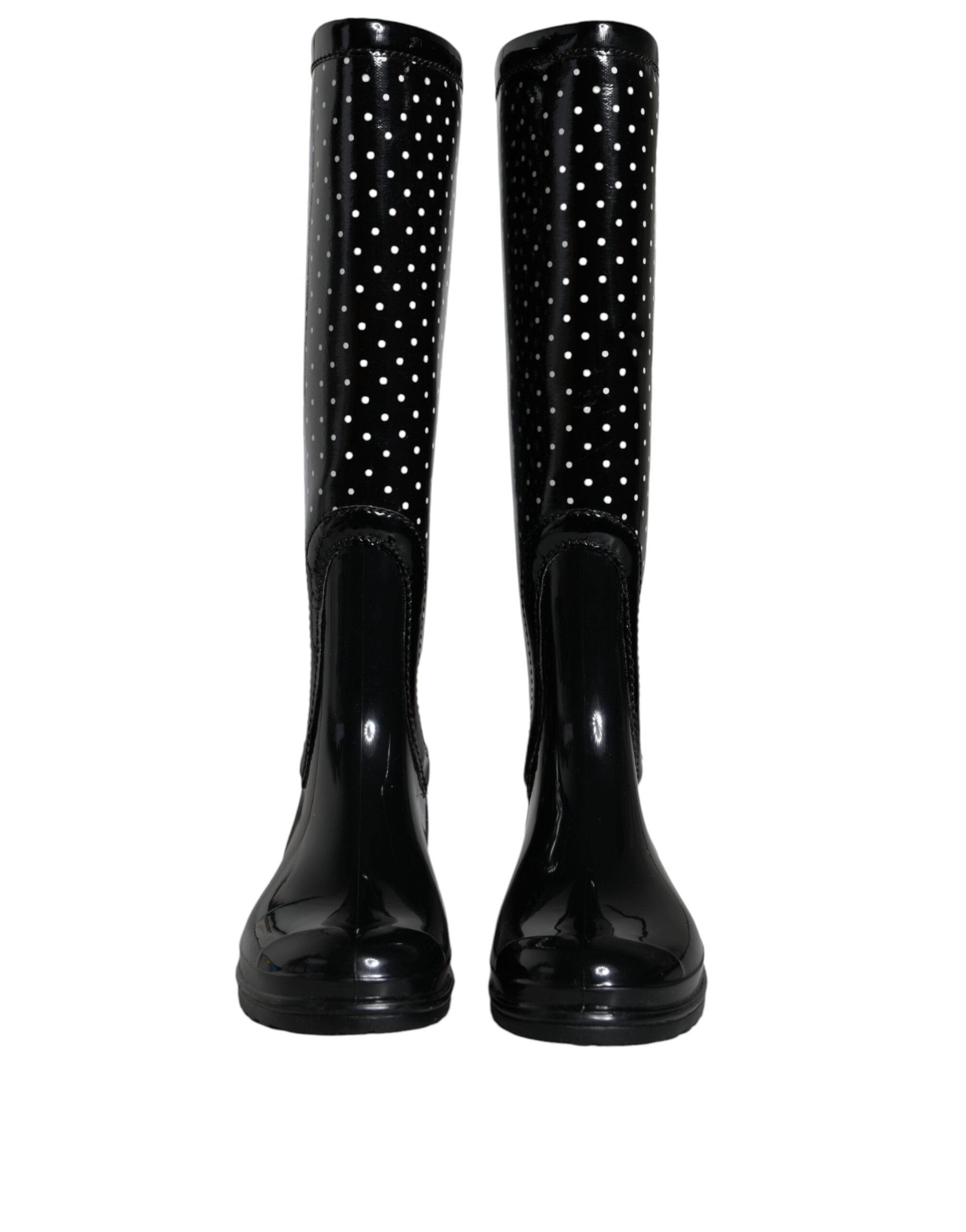 Black polka dot rubber knee-high boots by Dolce & Gabbana, featuring a glossy finish and classic polka dot pattern.