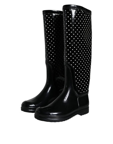 Black polka dot rubber knee-high boots by Dolce & Gabbana with a glossy finish and stylish design.