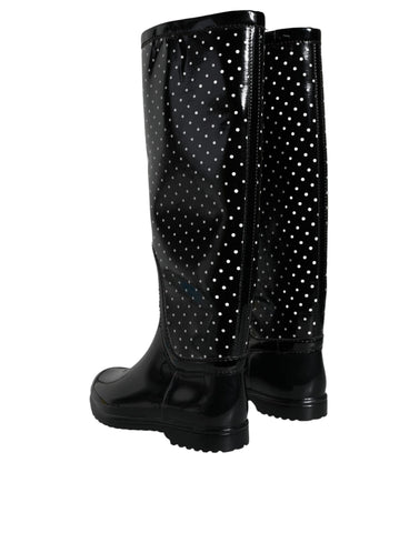 Black polka dot rubber knee-high boots by Dolce & Gabbana with chunky soles and tall shaft, stylish rain footwear.