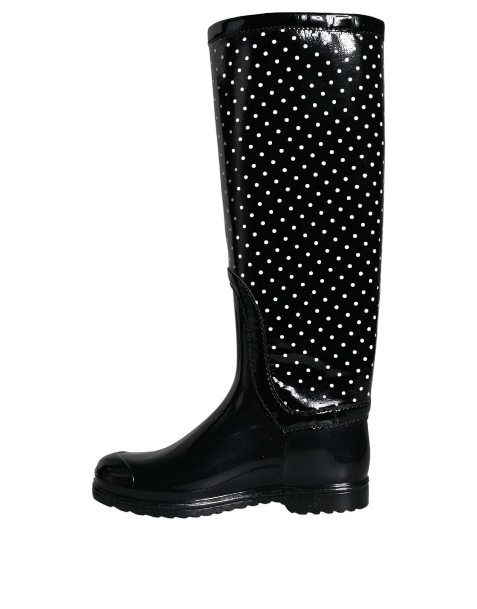 Black polka dot rubber knee-high boots by Dolce & Gabbana, showing the stylish footwear with polka dot pattern and glossy finish.