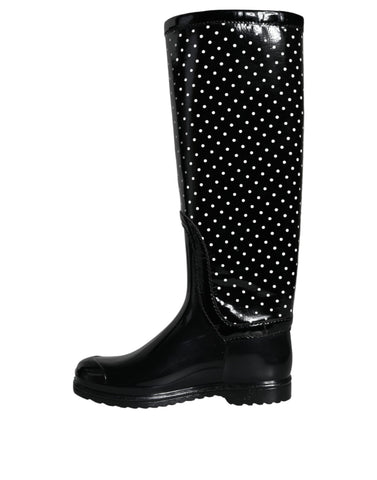 Black polka dot rubber knee-high boots by Dolce & Gabbana, showing the stylish footwear with polka dot pattern and glossy finish.