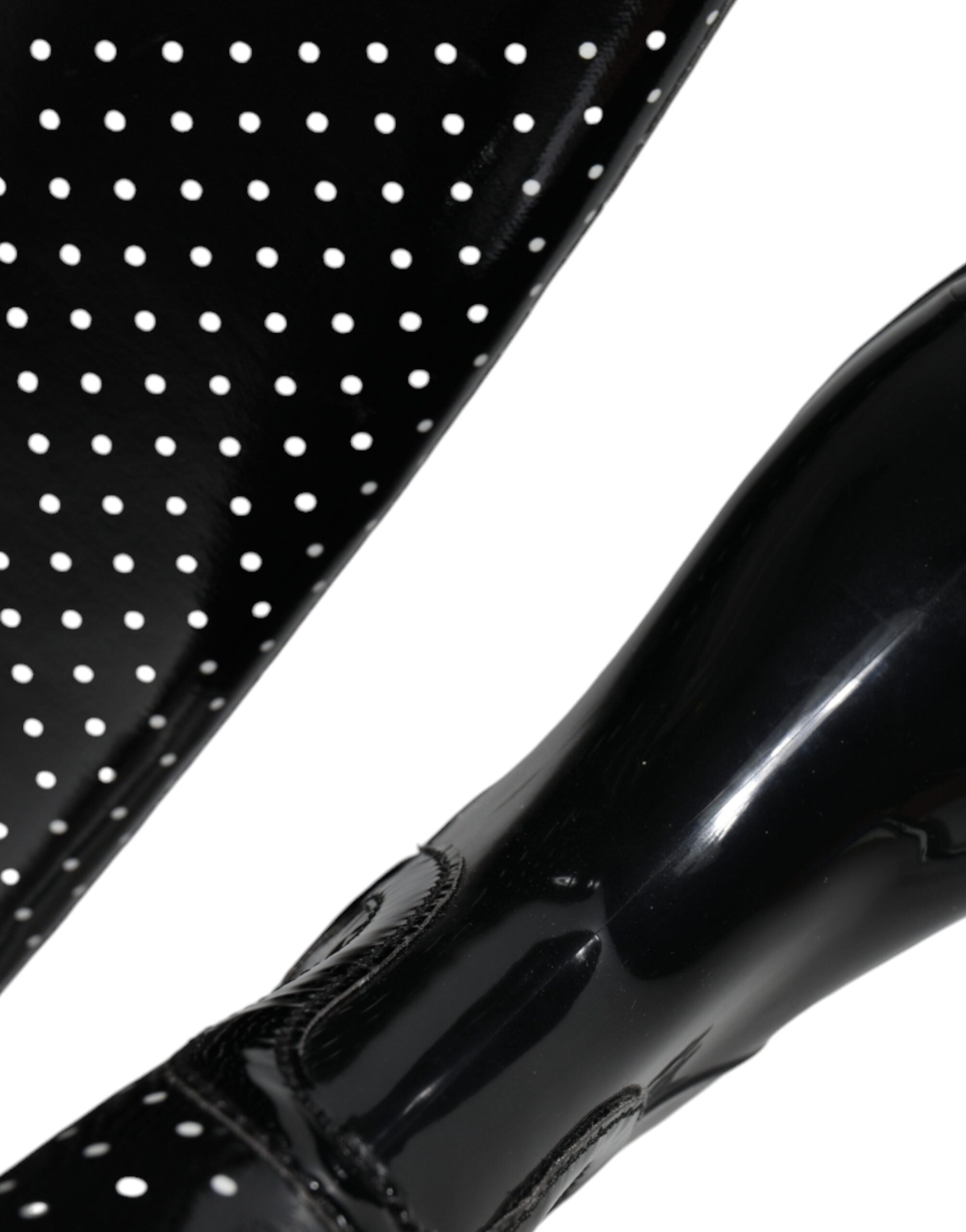 Black polka dot rubber knee-high boots by Dolce & Gabbana, showcasing shiny material and stylish polka dot pattern.