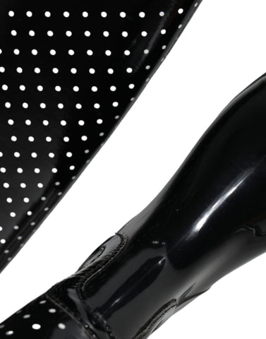 Black polka dot rubber knee-high boots by Dolce & Gabbana, showcasing shiny material and stylish polka dot pattern.