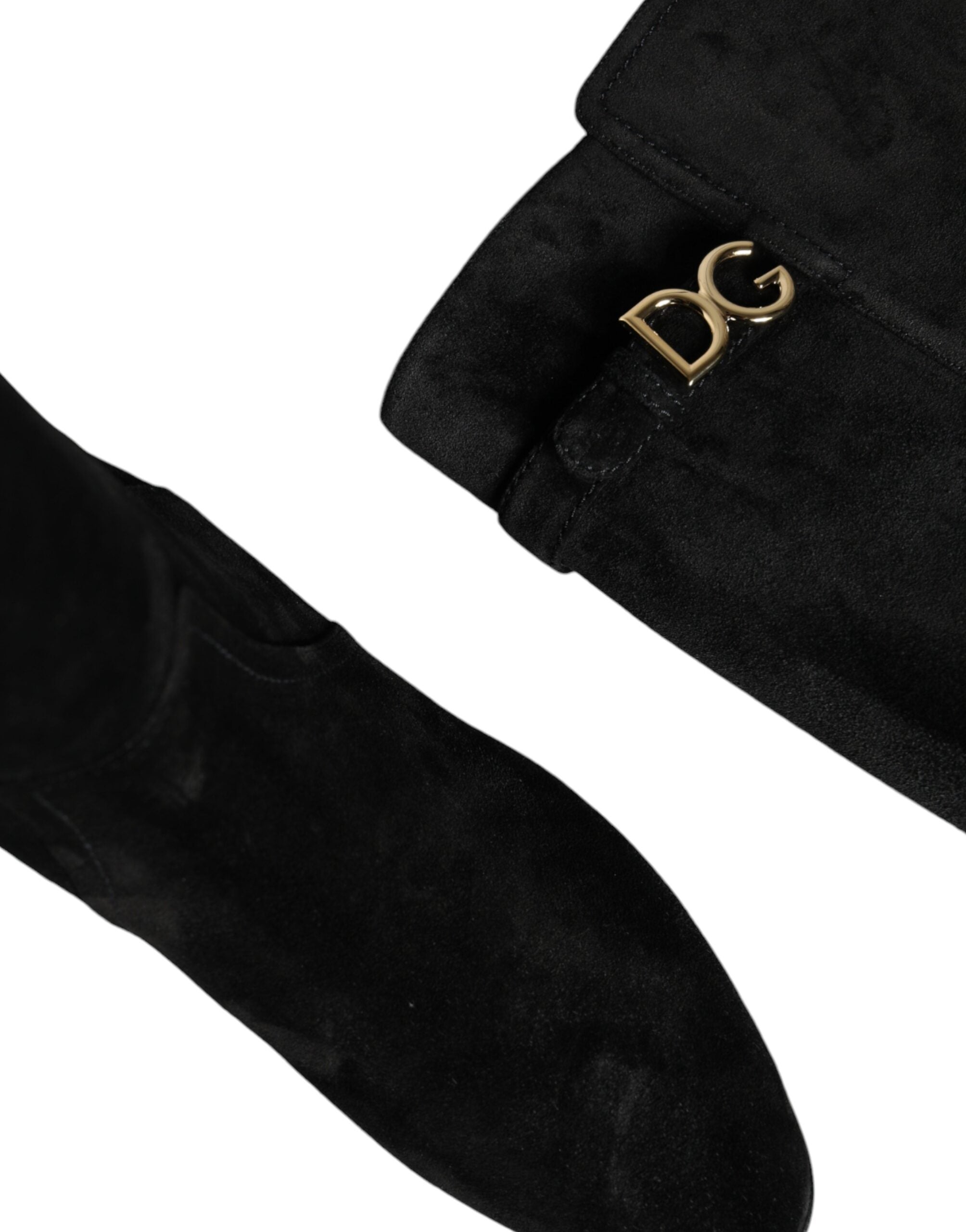 Black suede leather knee-high boots by Dolce & Gabbana with sleek design and pointed toes.