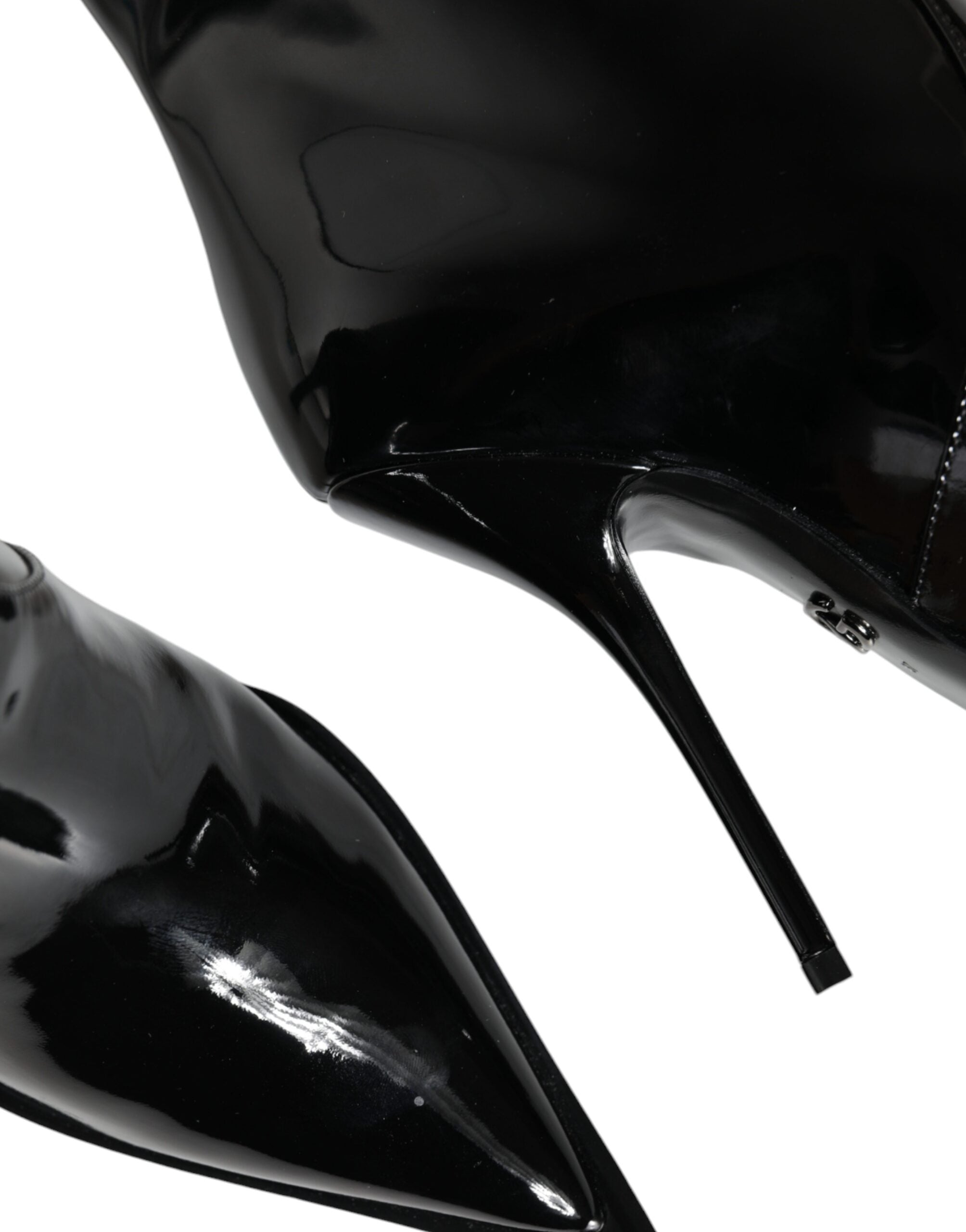 Black patent leather mid-calf boots by Dolce & Gabbana, stylish footwear with sleek shiny finish and classic silhouette.