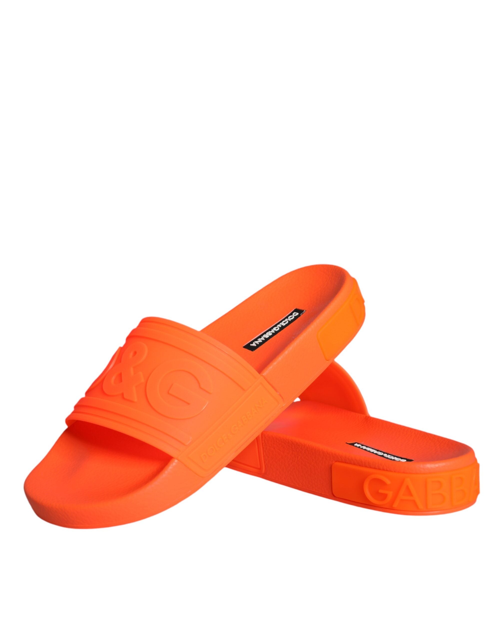 Orange rubber slides sandals by Dolce & Gabbana with a casual beachwear style and slip-on design.