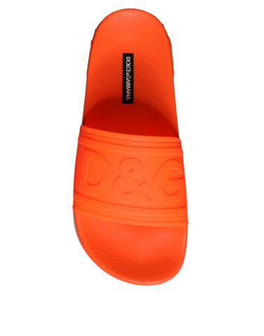 Orange rubber slides sandals by Dolce & Gabbana, featuring a casual beachwear style with open-toe design and slip-on fit.