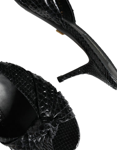 Black leather slide sandals with open-toe design from Dolce & Gabbana, featuring sleek, minimalist style and comfortable flat sole.