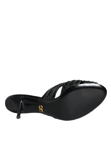 Black leather Dolce & Gabbana slide sandals with open toes and flat heels, featuring a sleek, minimalist design.