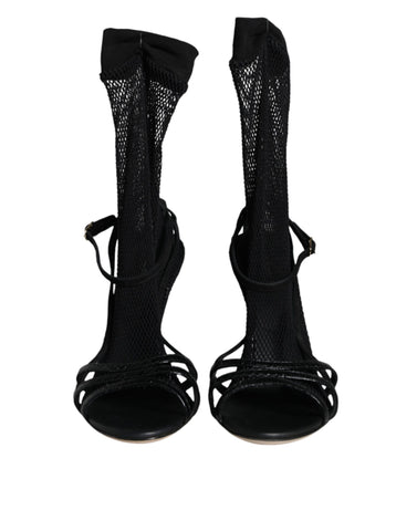 Black mesh stiletto heels sandals by Dolce & Gabbana featuring open toes and high slender heels.