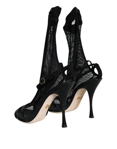 Black mesh stiletto heel sandals by Dolce & Gabbana, featuring open toes and sleek design on a plain background.
