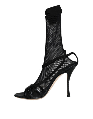 Black mesh stiletto heel sandals by Dolce & Gabbana, showcasing elegant open-toe design and slender high heels.