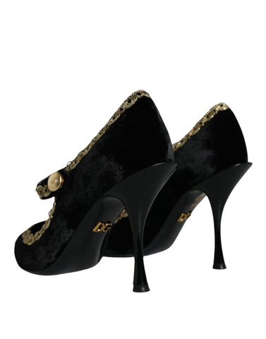 Black velvet Mary Jane pumps with gold accents and low heels, stylish Dolce & Gabbana shoes on a white background.