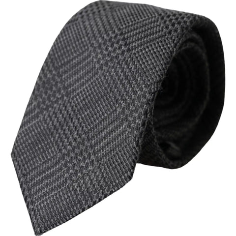 Dark gray silk men’s tie with plaid pattern, adjustable and from Dolce & Gabbana, shown laid flat on a white background.