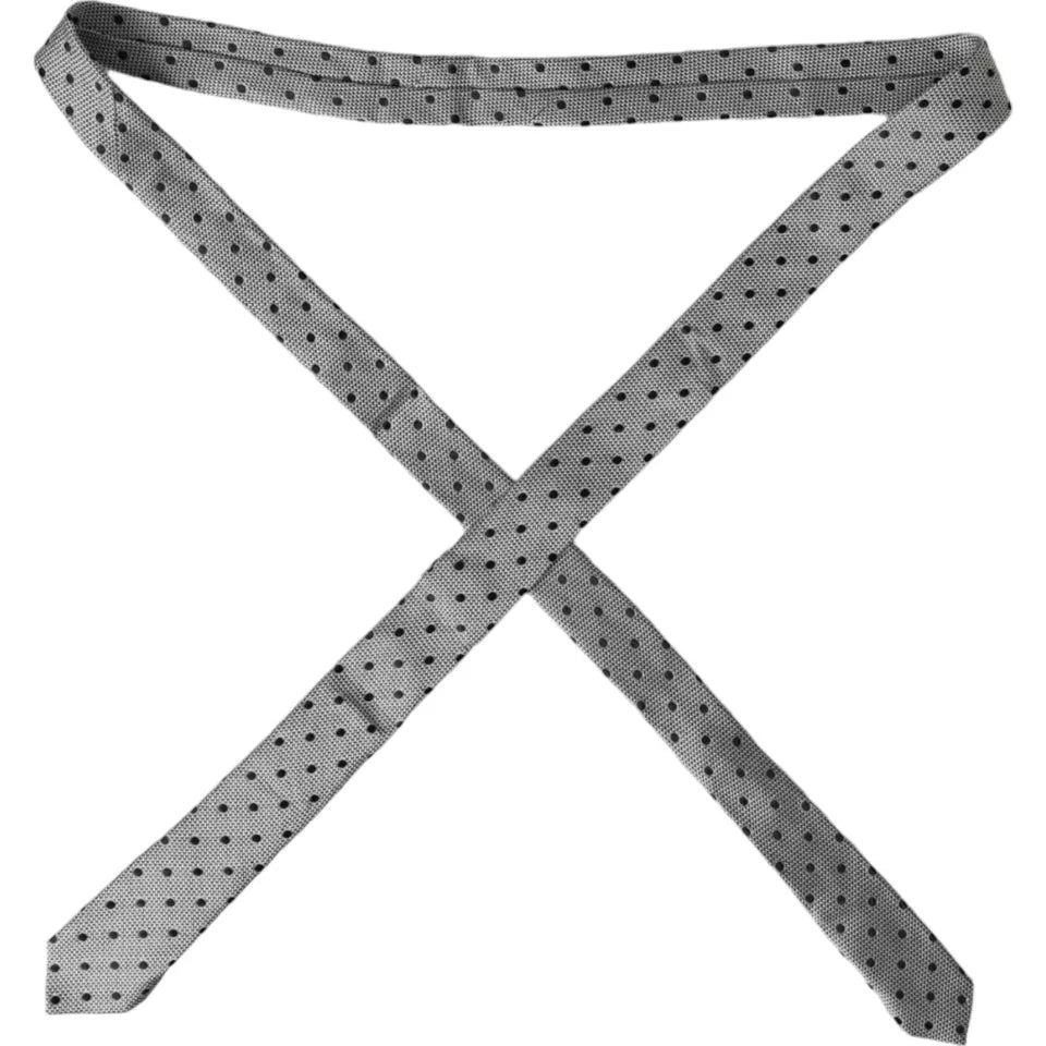 Dolce & Gabbana black and white dot fantasy silk adjustable men's tie laid flat showing the pattern and fabric texture.