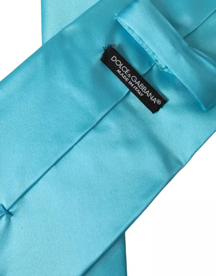 Light blue satin silk men's tie by Dolce & Gabbana with a wide, adjustable design, featuring a smooth, glossy finish.
