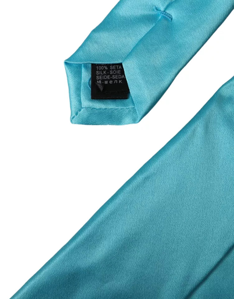 Light blue satin silk men's tie with wide adjustable design by Dolce & Gabbana, featuring a smooth, shiny finish.