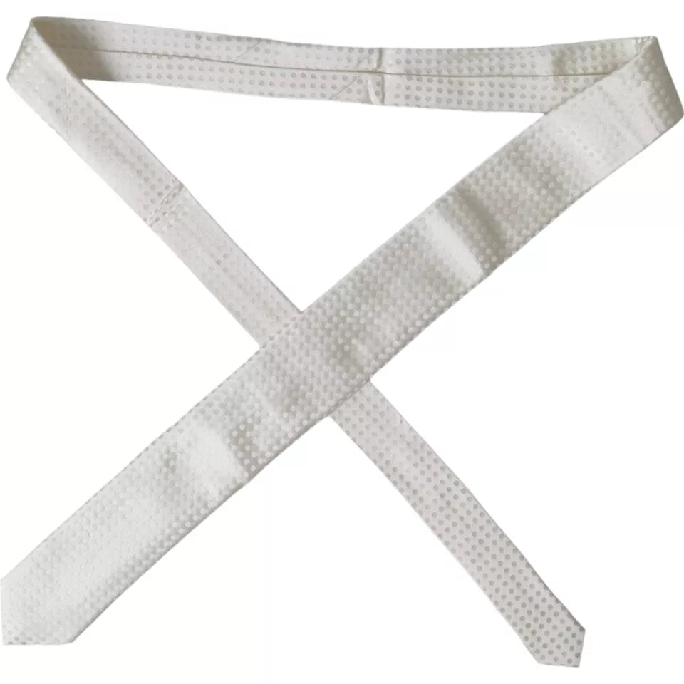White dotted silk classic men's tie by Dolce & Gabbana, featuring adjustable length and elegant design.