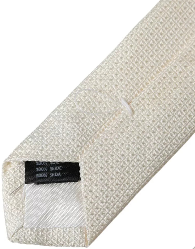 Dolce & Gabbana Off White patterned silk classic adjustable tie displayed on a plain background.