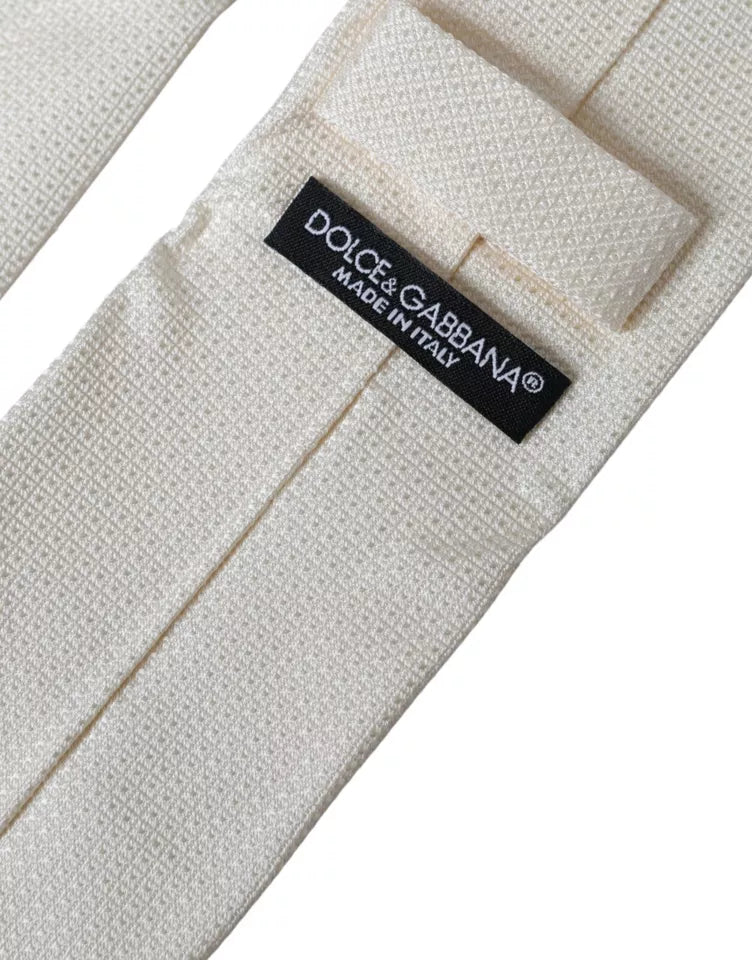Dolce & Gabbana off-white patterned silk classic adjustable tie displayed flat with intricate design details.