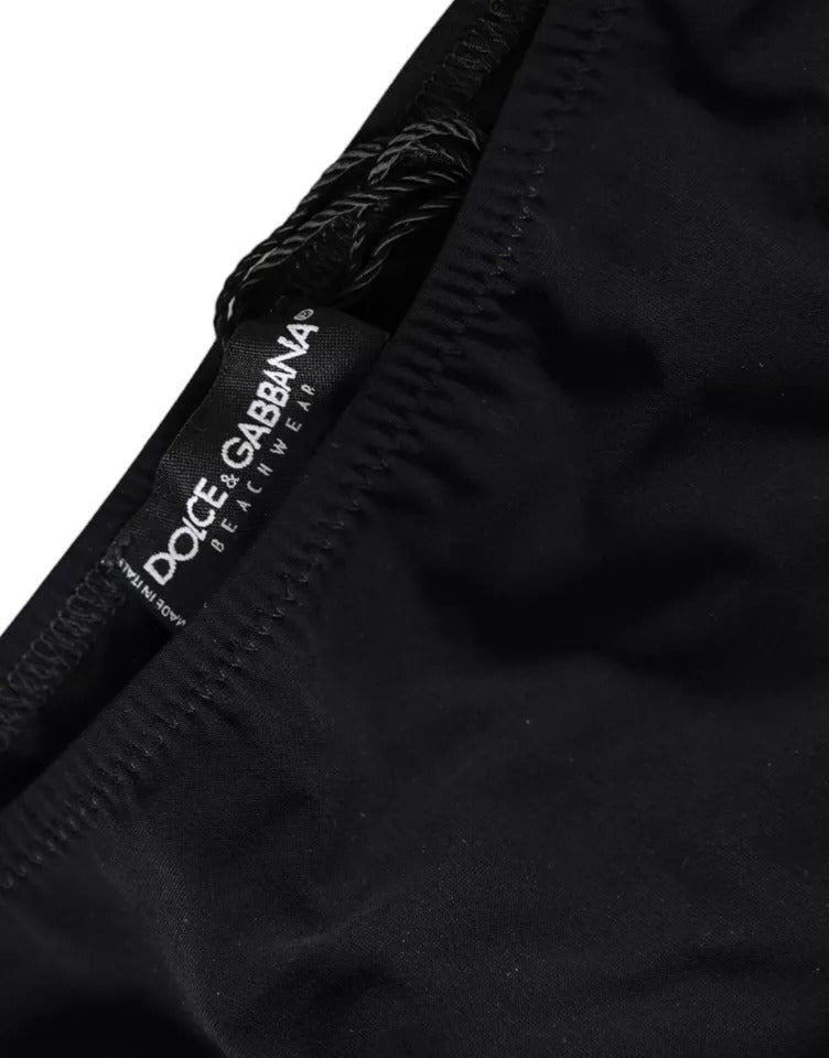 Black nylon beachwear bikini bottom by Dolce & Gabbana, featuring a sleek, fitted design for swimming and sunbathing.