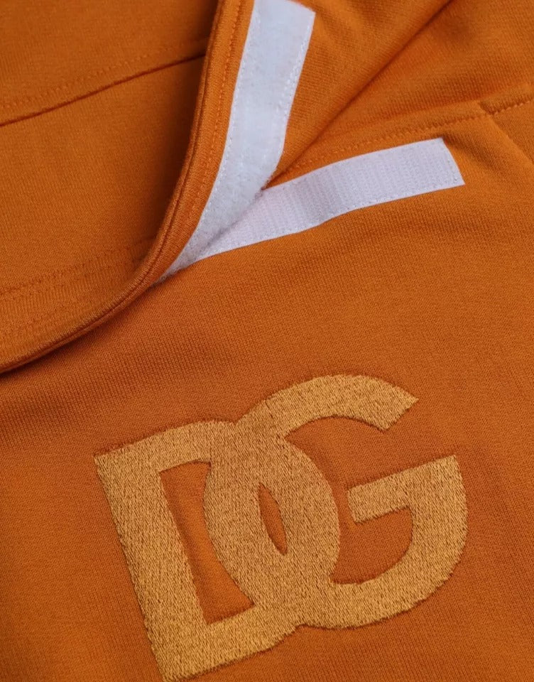 Orange Dolce & Gabbana hooded pullover sweatshirt with long sleeves and front pocket, displayed on a hanger.