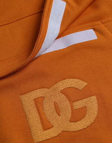 Orange Dolce & Gabbana hooded pullover sweatshirt with long sleeves and front pocket, displayed on a hanger.