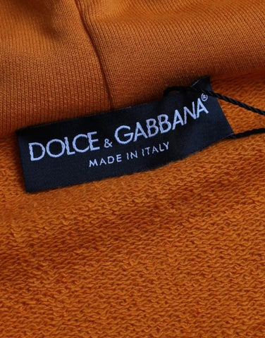 Orange Dolce & Gabbana hooded sweatshirt with a relaxed fit and ribbed cuffs, showcasing a stylish pullover sweater.
