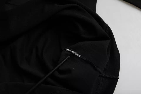 Black cotton crew neck T-shirt with embossed Dolce & Gabbana logo on chest, casual and stylish men's clothing.