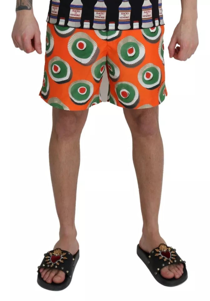 Orange cupcake-themed Dolce & Gabbana beachwear shorts with swimwear fabric, featuring a playful, vibrant design perfect for summer.