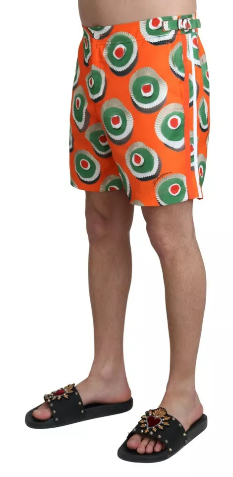 Orange cupcake print beachwear shorts by Dolce & Gabbana, featuring a fun and stylish swimwear design perfect for summer.