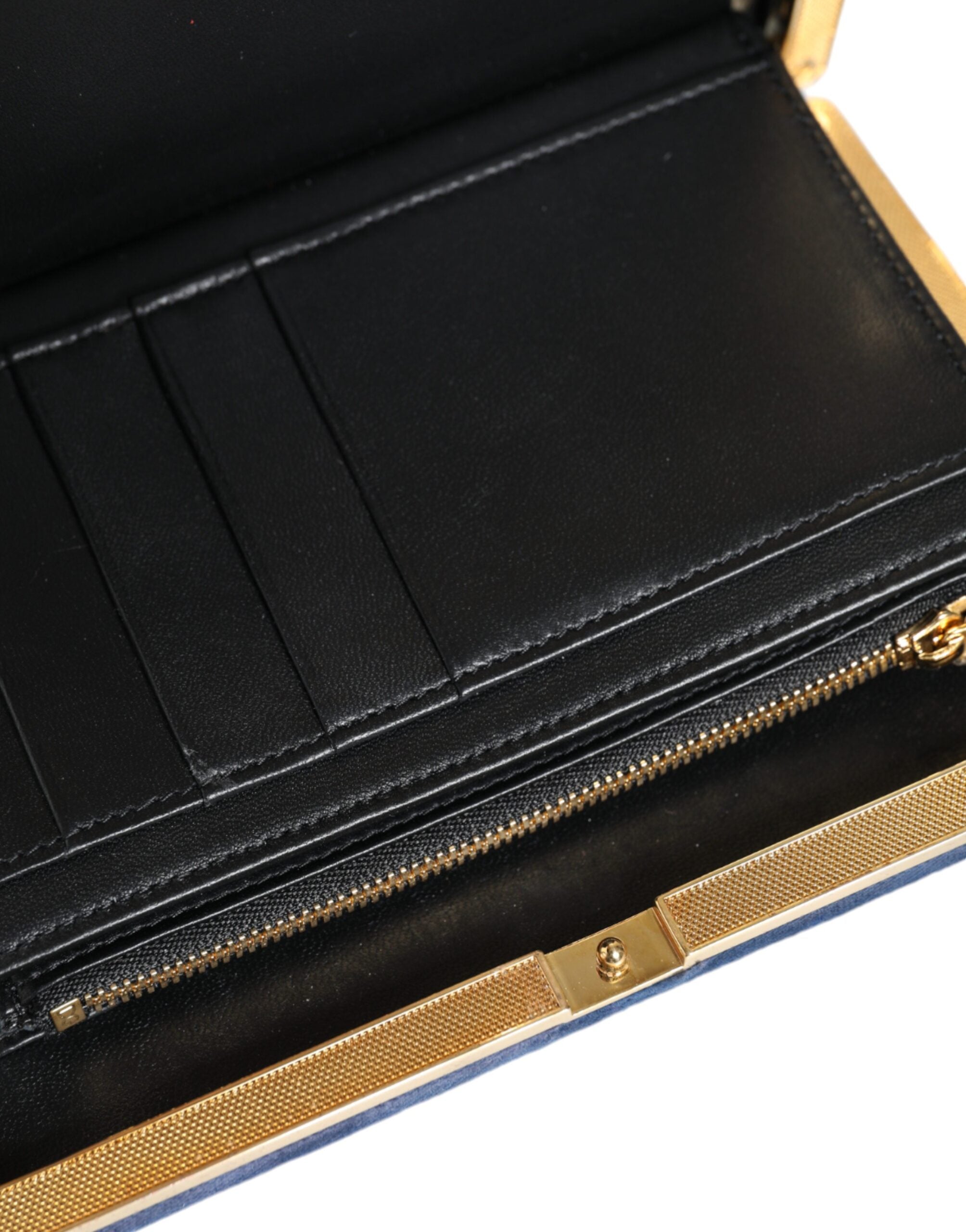 Blue velvet clutch purse with gold frame, designed by Dolce & Gabbana, perfect for evening parties and elegant occasions.