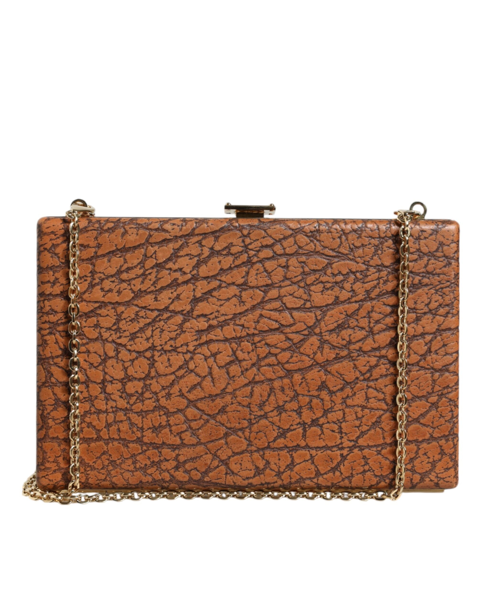 Brown leather clutch bag with gold frame and mini crossbody strap by Dolce & Gabbana, featuring a sleek, compact design.