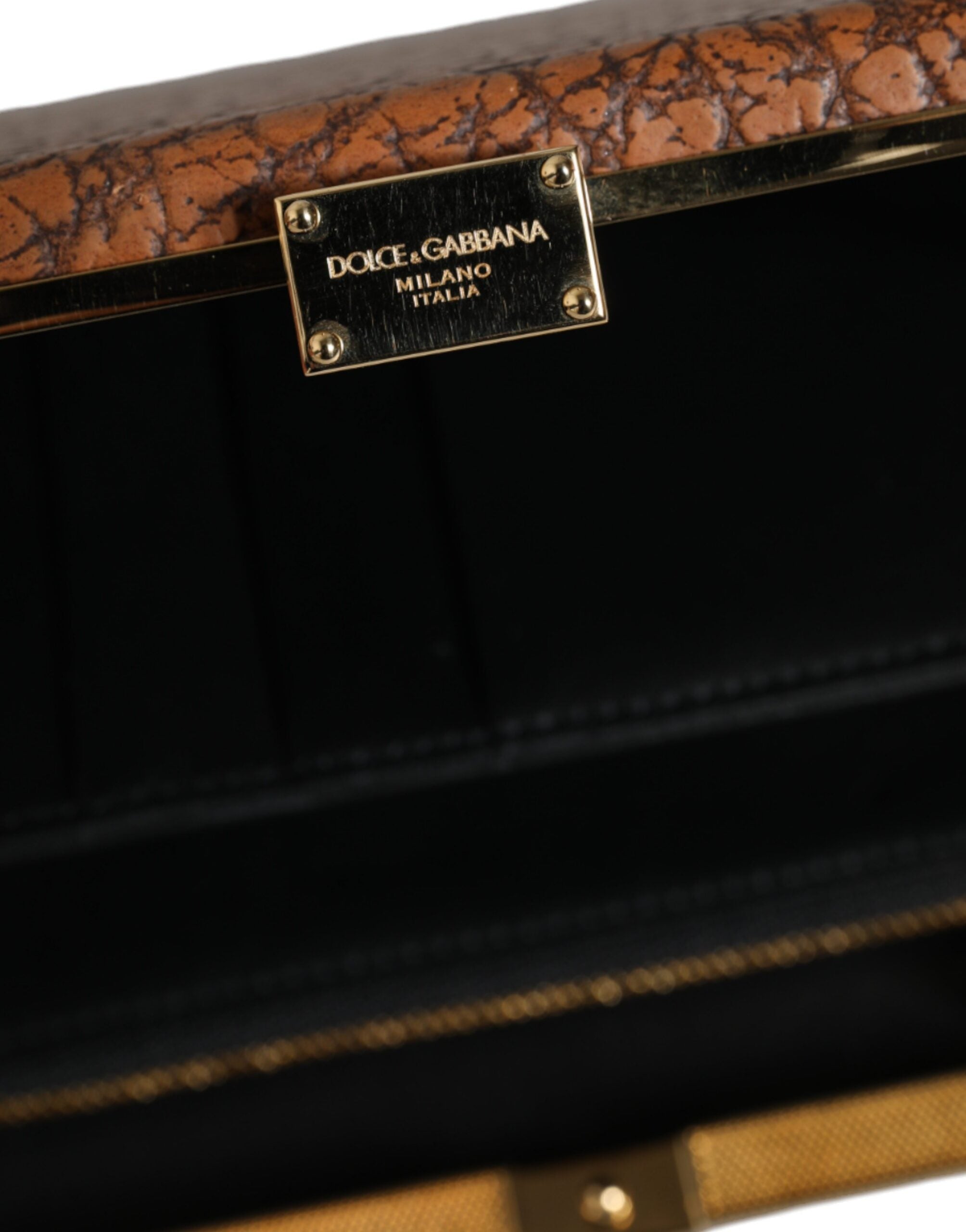 Brown leather mini crossbody clutch bag with gold frame from Dolce & Gabbana, featuring a sleek, compact design and elegant detailing.