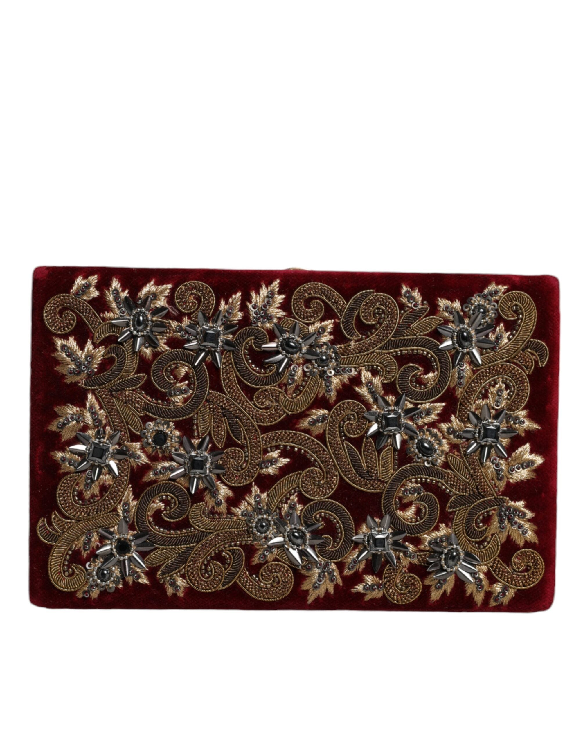 Red velvet clutch purse with gold frame, perfect for evening parties, by Dolce & Gabbana.