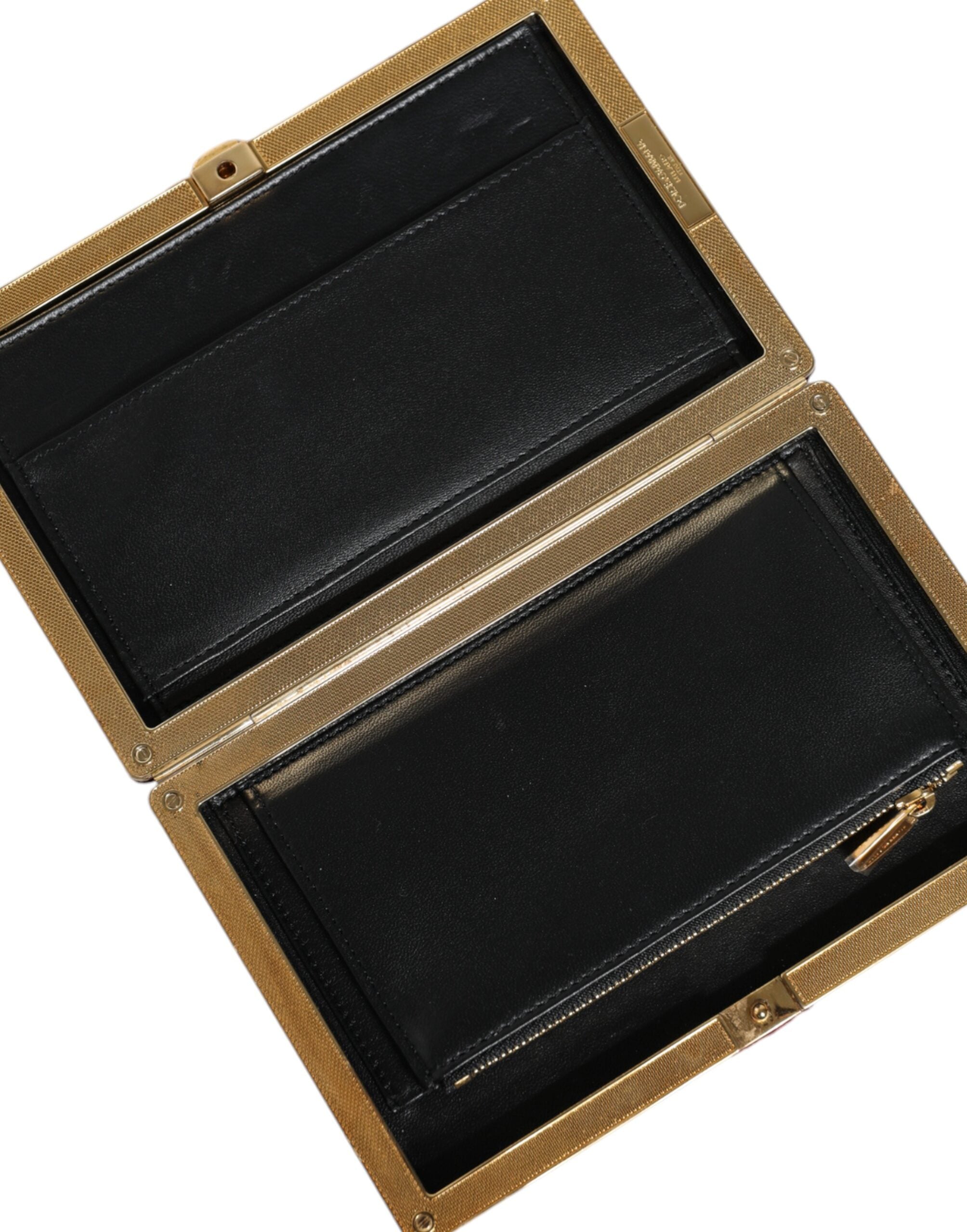 Red velvet clutch purse with gold frame, elegant evening party bag by Dolce & Gabbana, featuring a sleek, luxurious design.