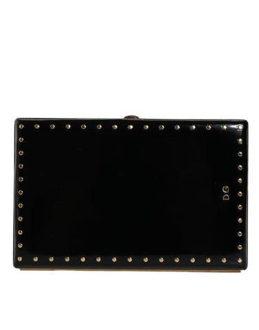 Black leather clutch purse with gold frame and stud accents, designed by Dolce & Gabbana, suitable for evening events.
