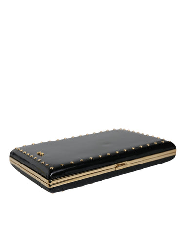 Black leather clutch purse with gold frame and stud accents, evening bag by Dolce & Gabbana, featuring a sleek, compact design.