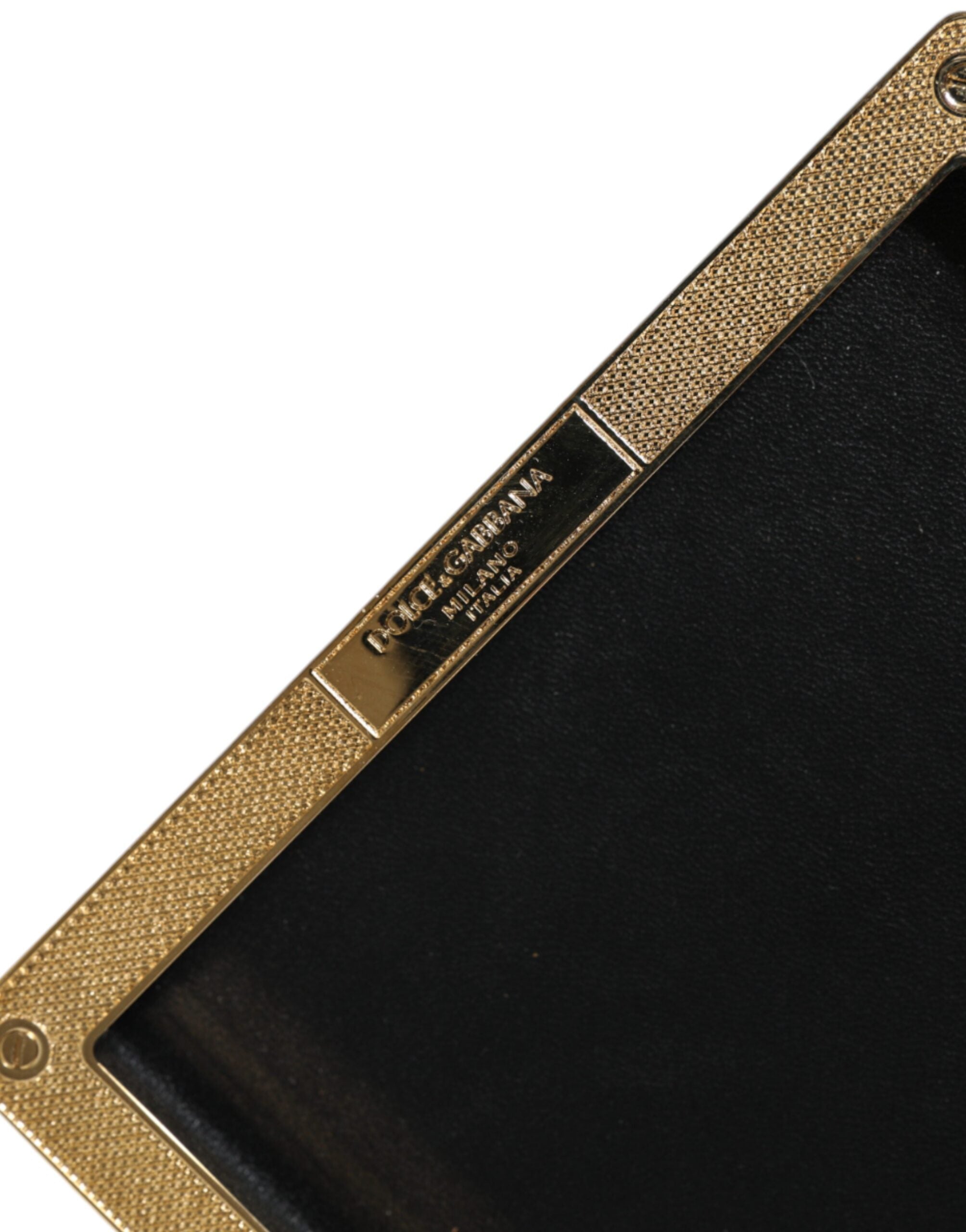 Black leather clutch purse with gold frame and stud details, designed by Dolce & Gabbana for evening events.