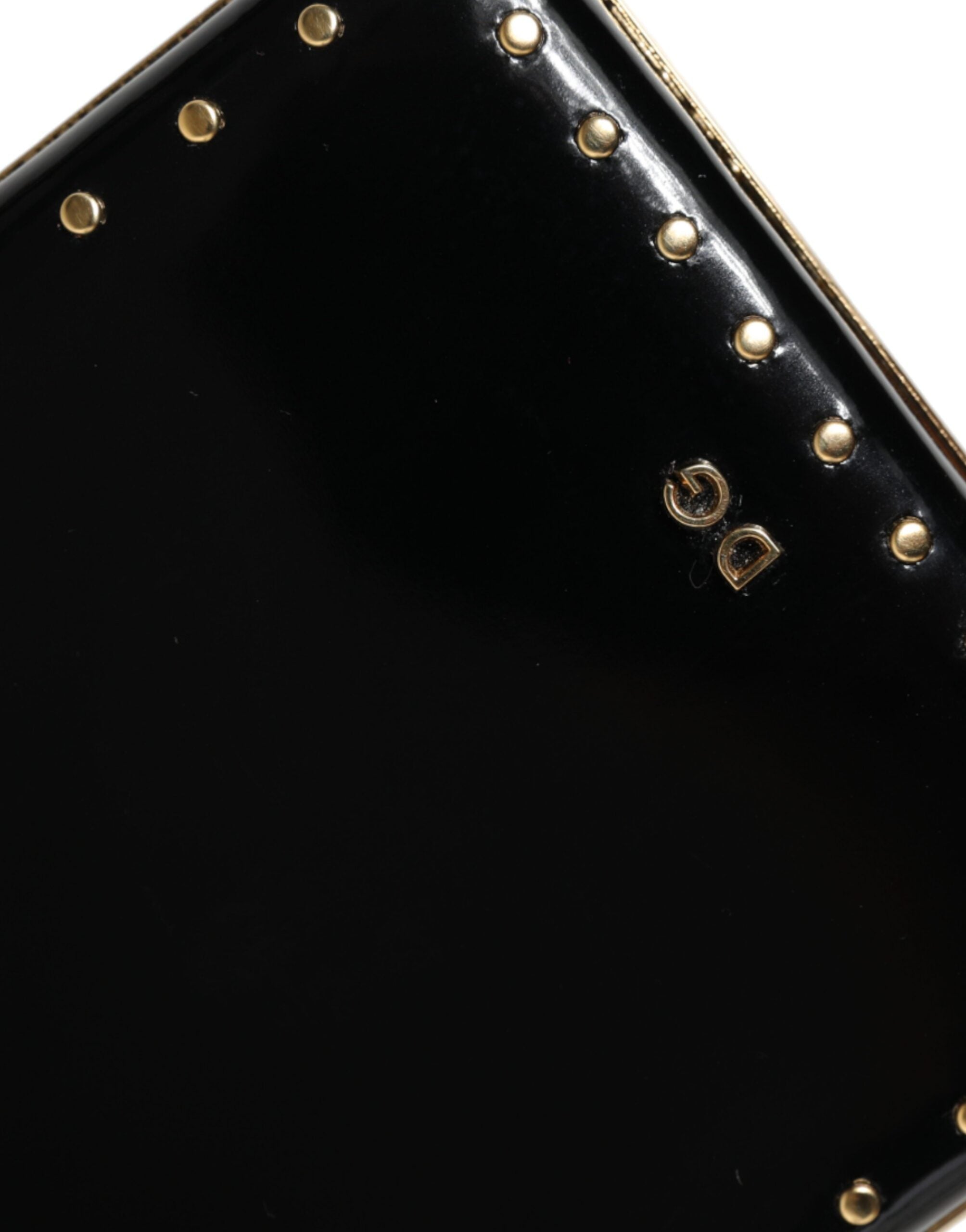 Black leather clutch purse with gold frame and stud accents, designed by Dolce & Gabbana, ideal for evening events.
