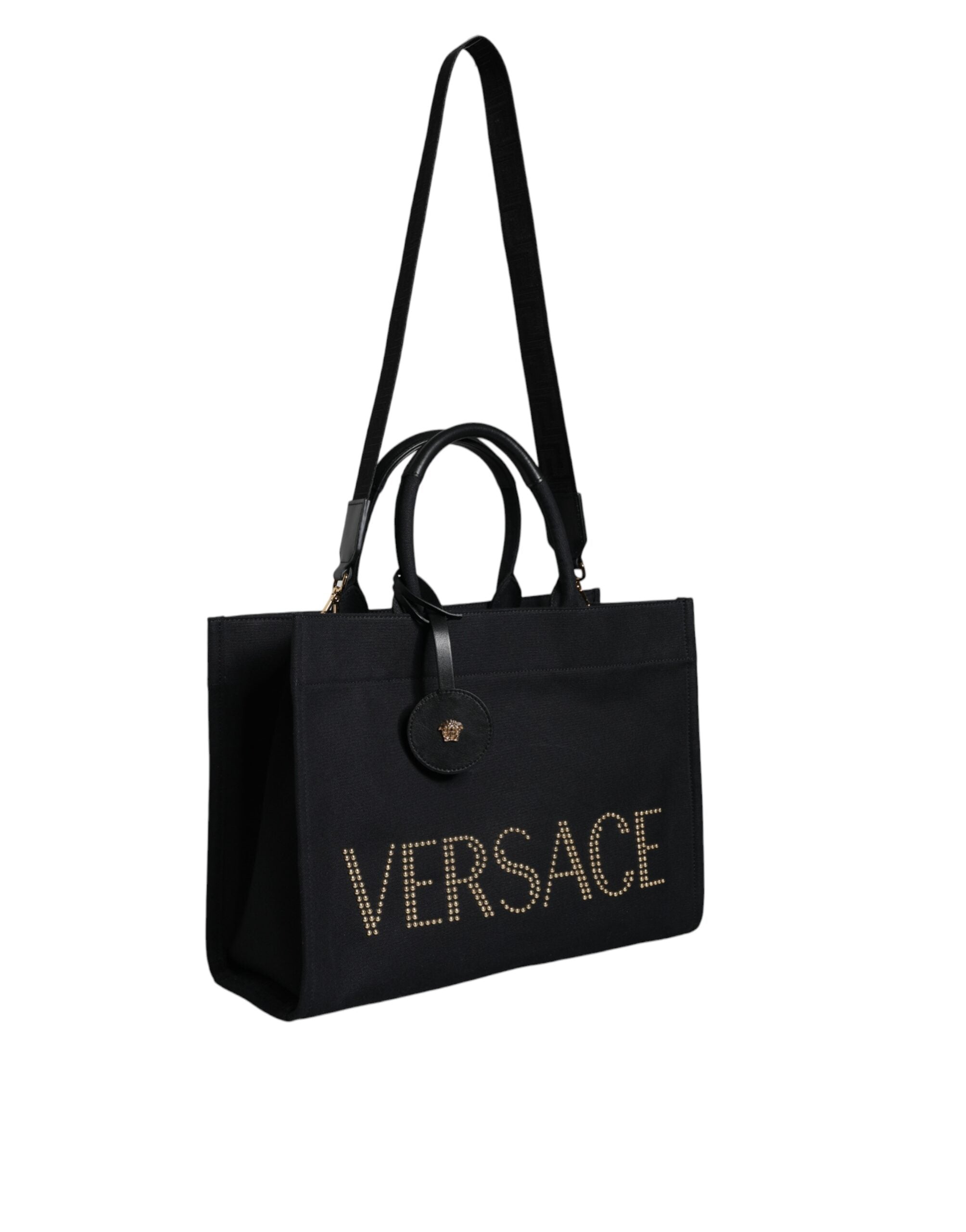 Versace black canvas and leather crossbody tote bag with top handle and logo details, stylish and spacious for everyday use.