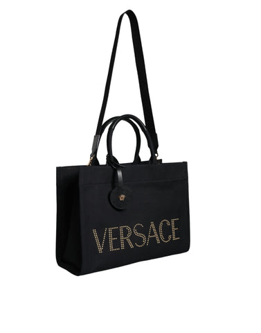 Versace black canvas and leather crossbody tote bag with top handle and logo details, stylish and spacious for everyday use.