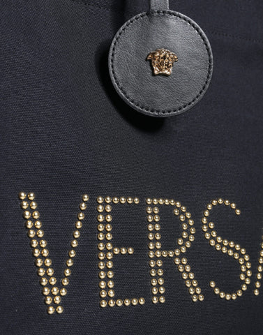 Versace black top handle canvas and leather logo crossbody tote bag with sturdy handles and spacious interior.