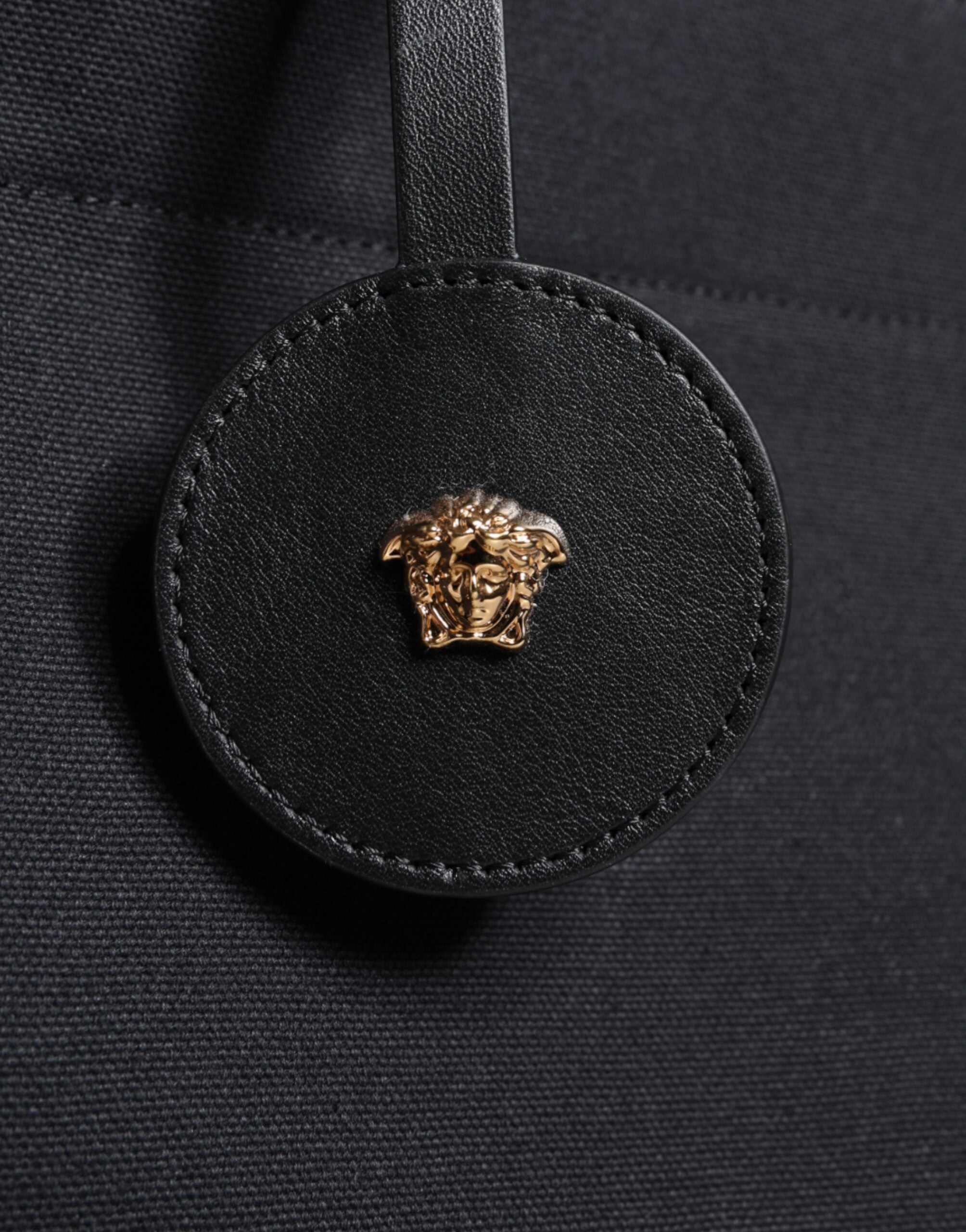 Versace black canvas leather logo crossbody tote bag with top handle, stylish and spacious for everyday use.