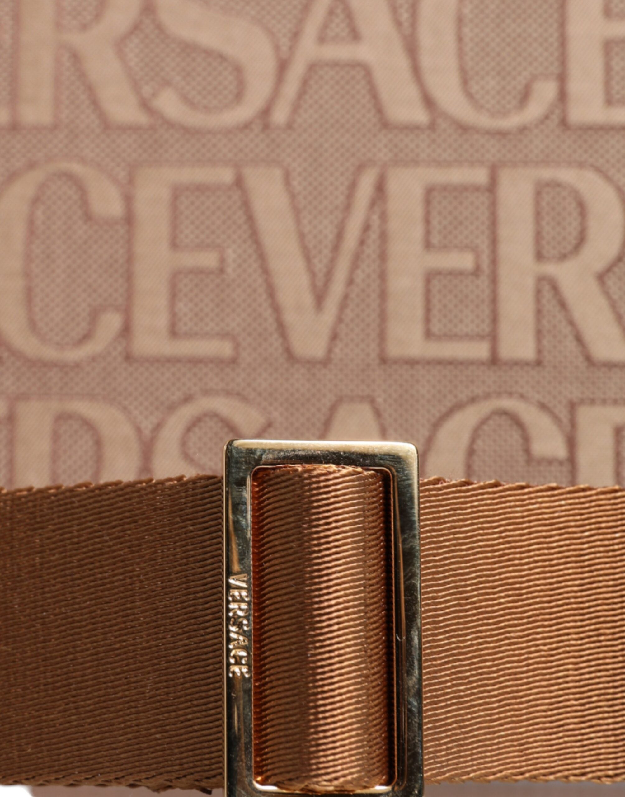 Versace brown top handle jacquard leather logo crossbody tote bag with structured shape and adjustable strap.