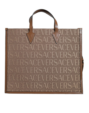 Brown Versace leather crossbody tote bag with top handle, jacquard pattern, and logo detailing.