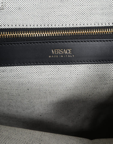 White Versace top handle canvas and leather logo crossbody tote bag with structured design and adjustable shoulder strap.
