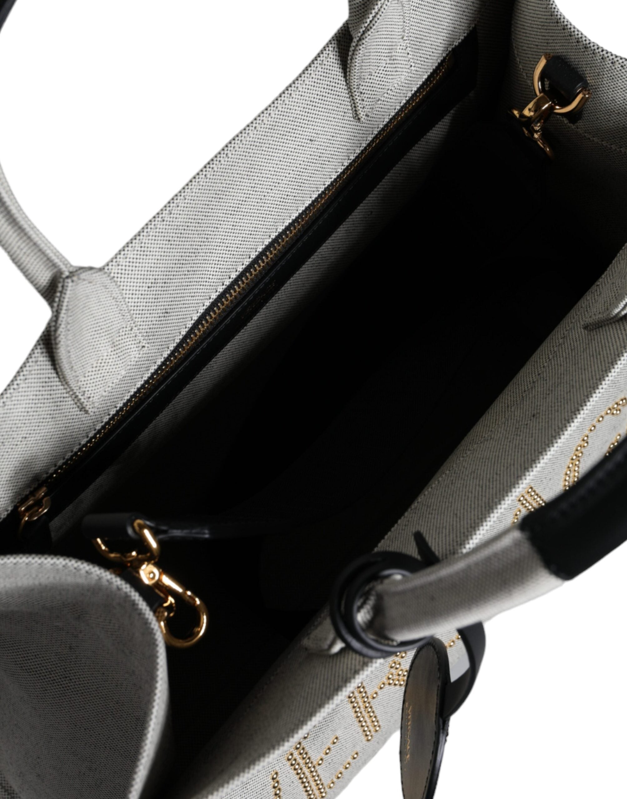 Versace white canvas and leather crossbody tote bag with top handle and logo detail, stylish and spacious for everyday use.