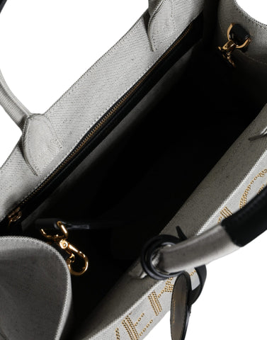 Versace white canvas and leather crossbody tote bag with top handle and logo detail, stylish and spacious for everyday use.